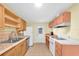 Functional kitchen with essential appliances, durable countertops, ample storage, and a convenient exterior door at 6628 Auburn Ave, Bradenton, FL 34207