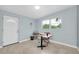 Office space with desk and chair, light blue walls, Terrazzo flooring, and natural light at 6628 Auburn Ave, Bradenton, FL 34207
