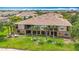 Aerial view of a condo building with manicured landscaping and palm trees at 7346 Skybird Rd # 417, Bradenton, FL 34209