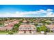 An aerial view shows the townhouse community with a serene pond, mature trees, and neatly arranged residential buildings at 7346 Skybird Rd # 417, Bradenton, FL 34209