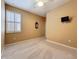 Bedroom with neutral walls, carpet, shutters on the window, and a ceiling fan at 7346 Skybird Rd # 417, Bradenton, FL 34209