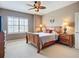 Cozy bedroom featuring a decorative ceiling fan and bright window at 7346 Skybird Rd # 417, Bradenton, FL 34209