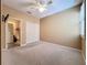 Spacious bedroom with neutral carpet, a ceiling fan, and access to a full bathroom at 7346 Skybird Rd # 417, Bradenton, FL 34209
