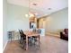 Well-lit dining area adjacent to kitchen with tile floor at 7346 Skybird Rd # 417, Bradenton, FL 34209