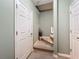 Hallway leading to stairs features light green walls, white doors, and carpeted stairs with an attractive entry at 7346 Skybird Rd # 417, Bradenton, FL 34209