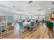 Well-lit event space with hardwood floors, white linens, large windows, and neutral paint palette at 7346 Skybird Rd # 417, Bradenton, FL 34209