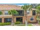 Rear exterior elevation featuring a private screened lanai and mature palm trees at 7346 Skybird Rd # 417, Bradenton, FL 34209