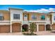Attractive townhouse showcases an attached garage, well maintained landscaping, and tan and white exterior paint at 7346 Skybird Rd # 417, Bradenton, FL 34209