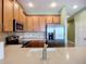 Light and airy kitchen shows stainless appliances, light countertops, and light green walls at 7346 Skybird Rd # 417, Bradenton, FL 34209