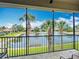 Screened lanai overlooking a tranquil lake framed by swaying palm trees at 7346 Skybird Rd # 417, Bradenton, FL 34209