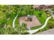 Aerial view of a well-maintained playground area surrounded by lush landscaping and walking paths at 7346 Skybird Rd # 417, Bradenton, FL 34209