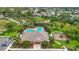 Aerial view of community pool, clubhouse, playground, parking, and well-maintained green spaces at 7346 Skybird Rd # 417, Bradenton, FL 34209