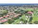 Aerial view showcasing residential community and golf course with clubhouse amenities at 7551 Calle Facil, Sarasota, FL 34238