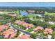 Scenic aerial view of the golf course community with lush greenery and serene lake at 7551 Calle Facil, Sarasota, FL 34238