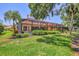 Lush backyard with screened in lanai showcasing a pool and well-manicured lawn at 7551 Calle Facil, Sarasota, FL 34238