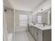 Modern bathroom with a shower, dual sinks, and stylish fixtures creates a spa-like experience at 7551 Calle Facil, Sarasota, FL 34238