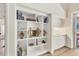 Elegant built-in shelving with decorative items, adjacent to white cabinets and a sliding glass door at 7551 Calle Facil, Sarasota, FL 34238