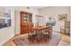 Traditional dining room featuring a wooden table, hutch, and area rug at 7551 Calle Facil, Sarasota, FL 34238
