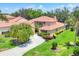 Beautiful two-story home showcasing tile roof, a spacious driveway and well-manicured lawn at 7551 Calle Facil, Sarasota, FL 34238