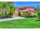 Charming two-story home featuring a tile roof, attached garage and vibrant landscaping at 7551 Calle Facil, Sarasota, FL 34238