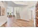 Bright and airy foyer featuring hardwood floors, a staircase, and high ceilings at 7551 Calle Facil, Sarasota, FL 34238