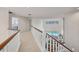 Upstairs hallway with view to the pool below featuring white railings and trim, and recessed lighting at 7551 Calle Facil, Sarasota, FL 34238