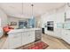 Open kitchen featuring a center island, modern appliances, and seamless flow to the living area at 7551 Calle Facil, Sarasota, FL 34238
