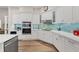 Modern kitchen with custom cabinets, stainless steel appliances, and a vibrant backsplash at 7551 Calle Facil, Sarasota, FL 34238