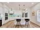 Modern kitchen with a center island, stainless steel appliances, and stylish bar stools at 7551 Calle Facil, Sarasota, FL 34238