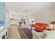 Open concept living space with wood flooring and a view of the kitchen with breakfast bar at 7551 Calle Facil, Sarasota, FL 34238