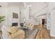 Bright living room featuring a fireplace, high ceilings, and a staircase with white banisters at 7551 Calle Facil, Sarasota, FL 34238