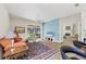 Cozy living room featuring comfortable seating, a stylish rug, and a view of the outdoor pool area at 7551 Calle Facil, Sarasota, FL 34238