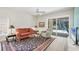 Bright living room featuring a ceiling fan and sliding glass doors to the outdoor pool at 7551 Calle Facil, Sarasota, FL 34238