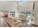 Spacious living room boasting high ceilings, built-in shelving, and a view of the pool at 7551 Calle Facil, Sarasota, FL 34238