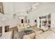 Spacious living room boasts a fireplace, built-in shelves, and a staircase leading to the upper level at 7551 Calle Facil, Sarasota, FL 34238