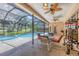 Inviting screened-in patio with a seating area overlooking the pool and lush landscaping at 7551 Calle Facil, Sarasota, FL 34238