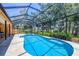 Stunning screened-in pool and spa, surrounded by lush landscaping and scenic views at 7551 Calle Facil, Sarasota, FL 34238