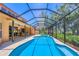 Screened-in pool and spa area with outdoor dining space offers a relaxing oasis at 7551 Calle Facil, Sarasota, FL 34238