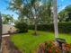 The backyard is meticulously landscaped with mature trees and seasonal flowers at 7641 Quinto Dr, Sarasota, FL 34238