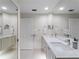 Bright bathroom with a double vanity, white countertops, and plenty of cabinet space at 7641 Quinto Dr, Sarasota, FL 34238