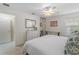 Bright bedroom featuring wood-look tile floors, a ceiling fan, and a mirrored closet at 7641 Quinto Dr, Sarasota, FL 34238