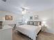 Bright bedroom featuring wood-look tile floors and a ceiling fan at 7641 Quinto Dr, Sarasota, FL 34238