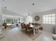 Open-concept dining area featuring a stylish table, comfortable chairs, and seamless flow to the living room at 7641 Quinto Dr, Sarasota, FL 34238