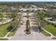 Impressive community entrance with manicured landscaping and elegant architecture at 7641 Quinto Dr, Sarasota, FL 34238