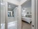 Hallway leading to a bathroom and bedroom with coordinated decor and natural light at 7641 Quinto Dr, Sarasota, FL 34238