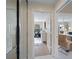 Hallway showing an open bedroom with an exercise bike and a cozy living room at 7641 Quinto Dr, Sarasota, FL 34238