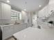 Spacious kitchen boasting white cabinets, ample counter space, and modern appliances for a delightful cooking experience at 7641 Quinto Dr, Sarasota, FL 34238