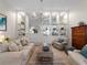 Well-lit living room featuring built-in shelving, a comfortable seating arrangement, and a decorative coffee table at 7641 Quinto Dr, Sarasota, FL 34238