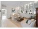 Inviting living room with neutral tones, decorative shelving, and ample seating for entertaining guests at 7641 Quinto Dr, Sarasota, FL 34238