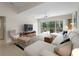 Relaxing living room with ceiling fan, sectional sofa, stylish rug, and view of the screened-in patio at 7641 Quinto Dr, Sarasota, FL 34238